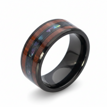 Load image into Gallery viewer, A black stainless steel band ring featuring a polished wood inlay with dark brown stripes and iridescent multicolor inclusions, shown on a white background.