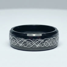 Load image into Gallery viewer, A black stainless steel ring with a silver patterned design on the surface, displayed against a white background.