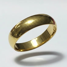 Load image into Gallery viewer, A classic yellow gold stainless steel band ring with a smooth, polished finish, against a light gray background with a soft shadow underneath.