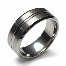 Load image into Gallery viewer, A brushed stainless steel band ring with a polished beveled edge, shown at an angle on a white background.