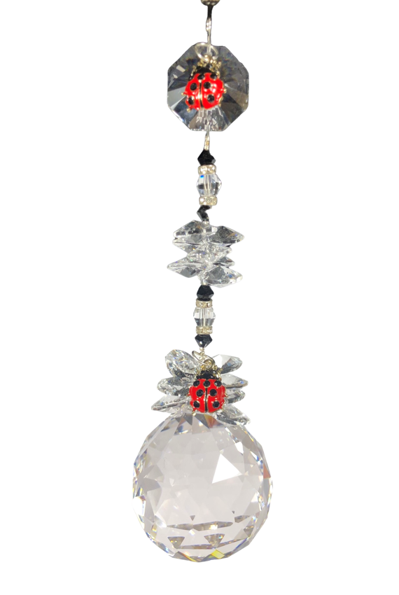 This beautiful Crystal ball suncatcher which is decorated with a Lady Bugs and Snowflake Obsidian
