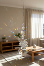 Load image into Gallery viewer, A clear crystal suncatcher with faceted beads and a ball design hanging from a thin wire in an indoor setting.
