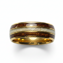 Load image into Gallery viewer, A gold-plated band ring featuring inlay stripes of dark brown wood, a textured off-white inlay, and a smooth white center stripe, shown on a white background.
