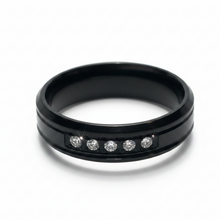Load image into Gallery viewer, A black metal band ring featuring five clear round-cut CZ set in a row on the front, photographed on a clean white background.
