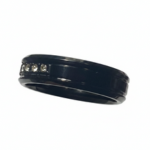 Load image into Gallery viewer, A black band ring with a row of five clear CZ on the left side, shown against a plain white background.
