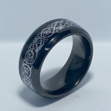Load image into Gallery viewer, A black stainless steel ring with a silver patterned design on the surface, displayed against a white background.
