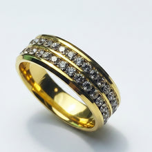 Load image into Gallery viewer, A gold band ring featuring three rows of small clear stones, photographed on a clean white background.
