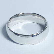Load image into Gallery viewer, A polished silver stainless steel band ring with a smooth, rounded profile, photographed on a clean light gray background.
