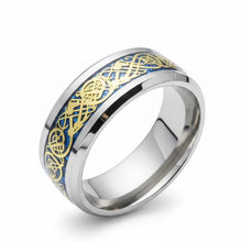 Load image into Gallery viewer, A polished silver-toned band ring featuring an inlaid blue and gold Celtic knot pattern, shown on a clean white background.
