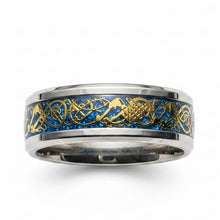 Load image into Gallery viewer, A silver-toned band ring featuring a vibrant blue inlay with gold Celtic knotwork and mountain designs, shown on a clean white background.
