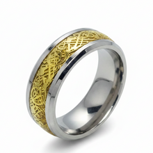 Load image into Gallery viewer, A stainless steel ring with a silver body and gold patterned detailing around the band.

