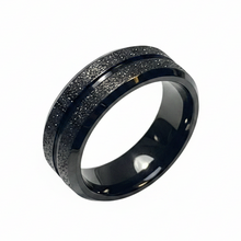 Load image into Gallery viewer, A black metallic ring band with a textured, speckled outer edge and a smooth, polished inner channel, shown on a plain white background.
