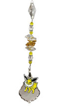 Load image into Gallery viewer, Pokémon Eevee evolution - Jolteon crystal suncatcher, decorated with 50mm starburst crystal and citrine gemstone.
