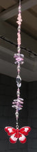 Load and play video in Gallery viewer, Pink &amp; red butterfly suncatcher is decorated with crystals and rose quartz gemstones
