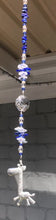 Load and play video in Gallery viewer, Giraffe suncatcher is decorated with crystals and lapis lazuli gemstones.
