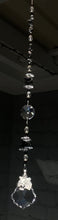 Load and play video in Gallery viewer, Tiger starburst suncatcher is decorated with crystals and Snowflake obsidian gemstones.
