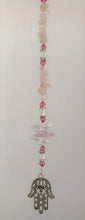 Load image into Gallery viewer, This beautiful Hand of Fatima suncatcher which is decorated with crystals and Rose Quartz
