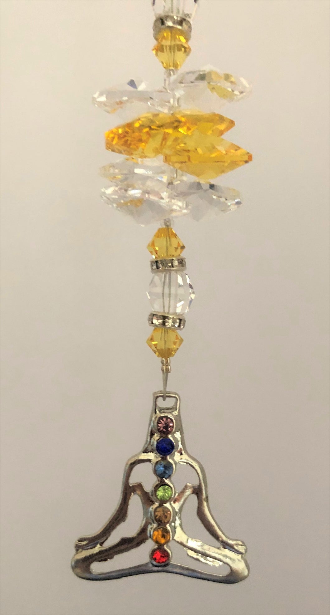 This beautiful Chakra Mediation coin suncatcher which is decorated with crystals and Citrine
