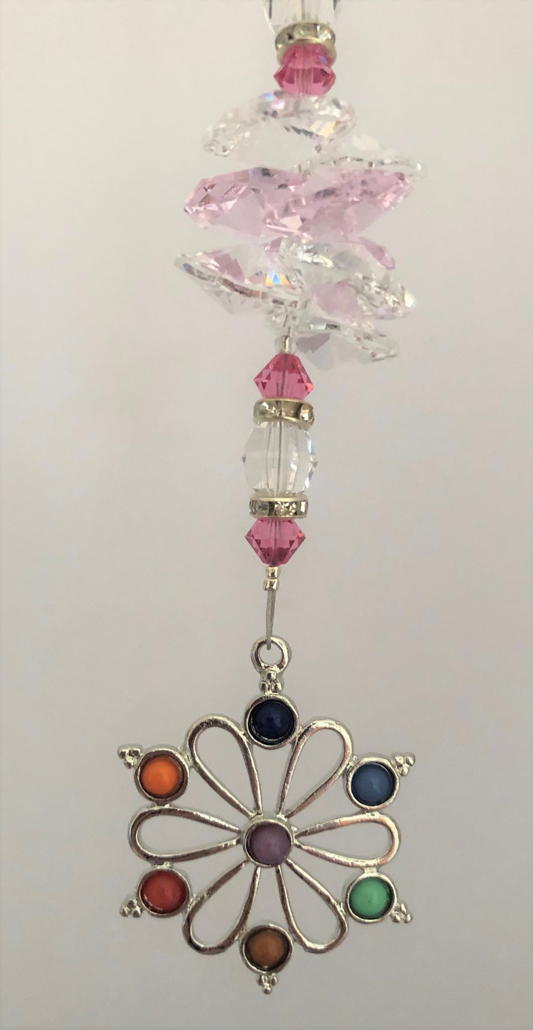 This beautiful Chakra Flower suncatcher which is decorated with crystals and Rose Quartz