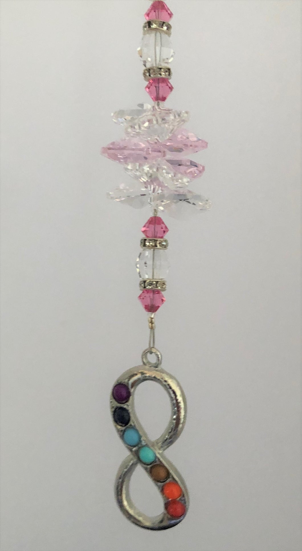 This beautiful Chakra Infinity suncatcher which is decorated with crystals and Moonstone