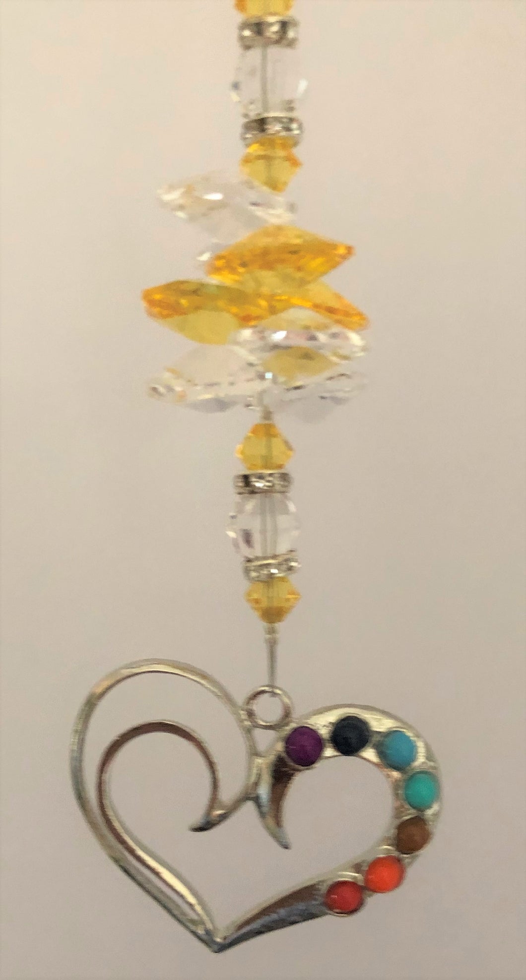 This beautiful Chakra Heart suncatcher which is decorated with crystals and Citrine
