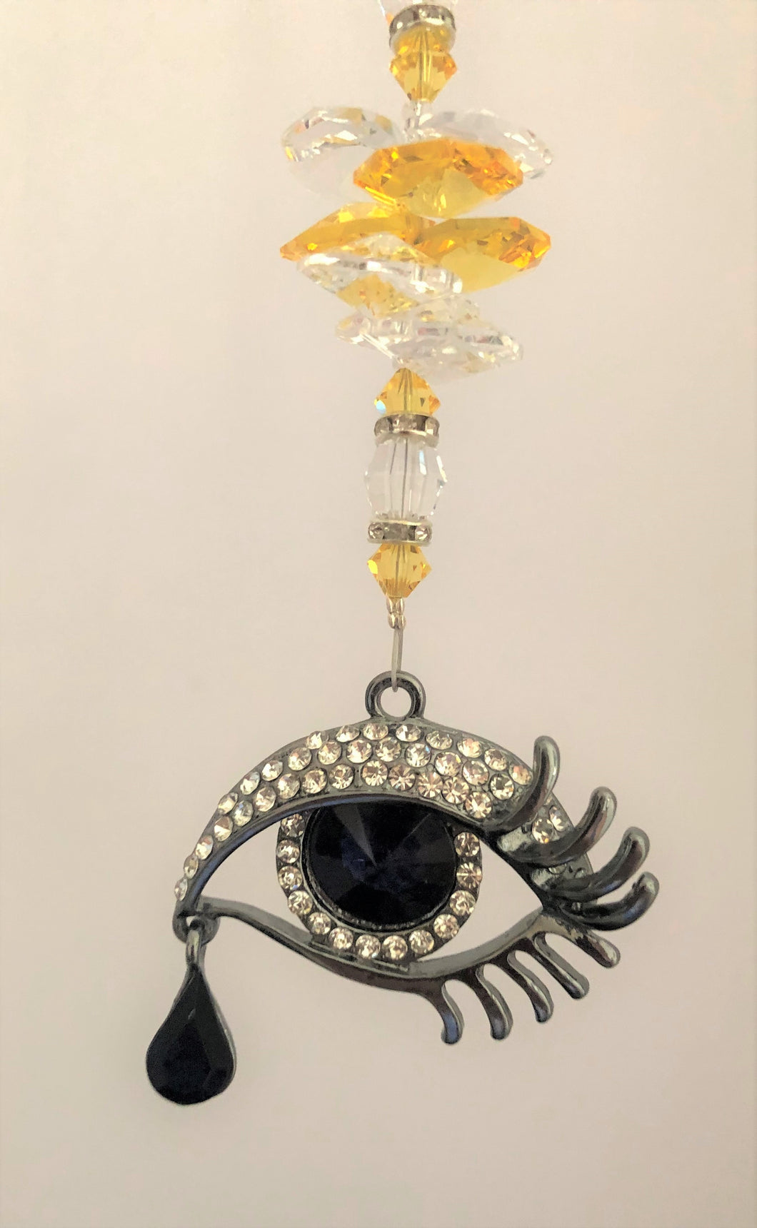This beautiful Evil Eye for Protection suncatcher which is decorated with crystals and Citrine
