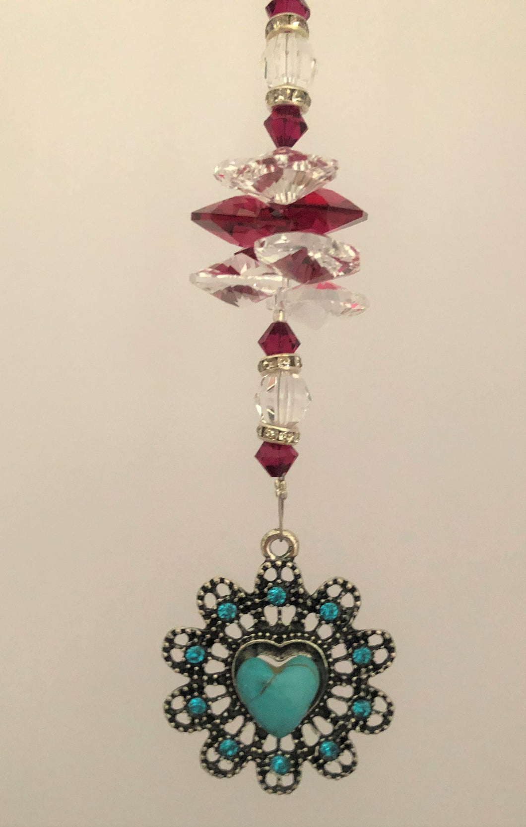 This beautiful Circle Heart suncatcher which is decorated with crystals and Garnet