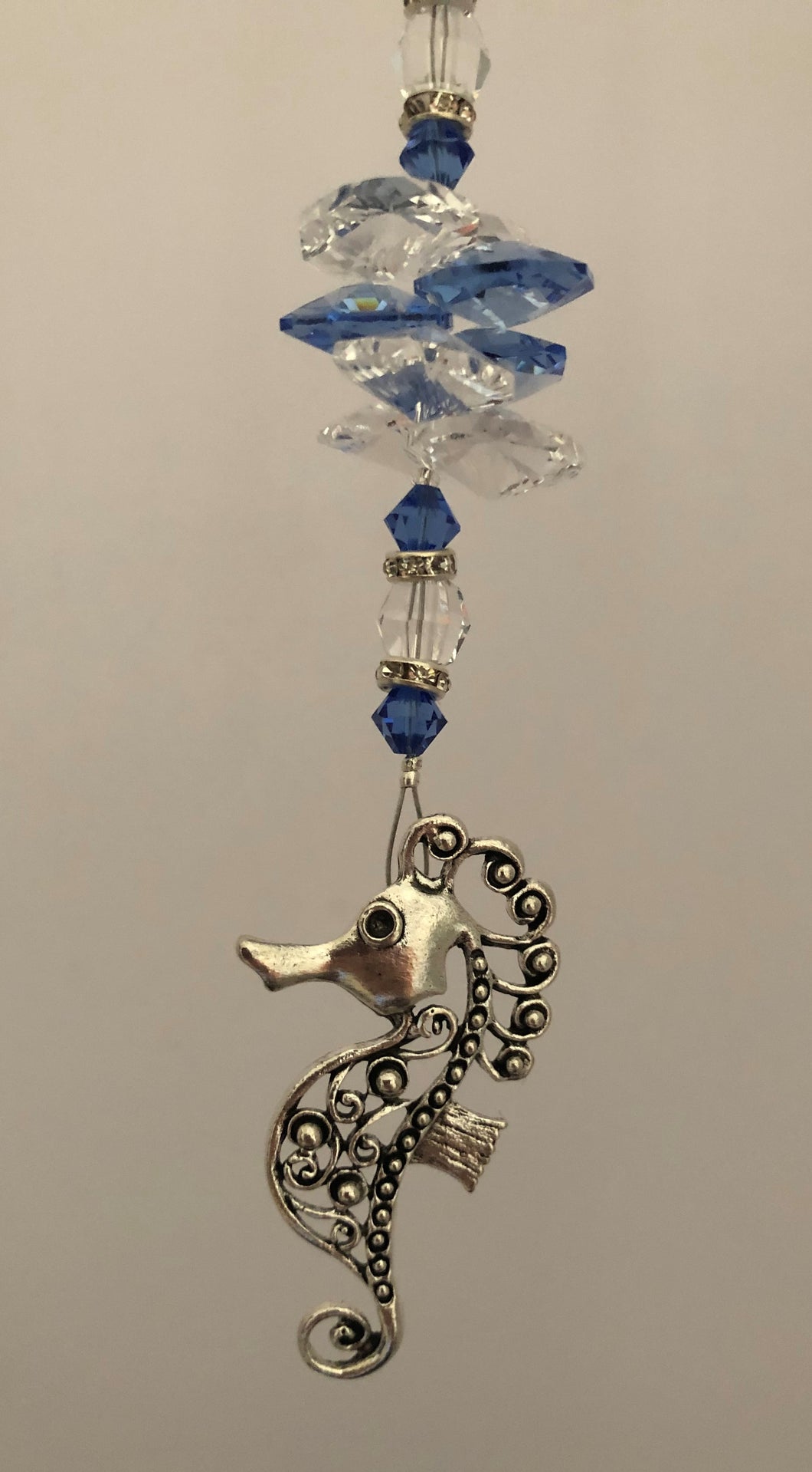 This beautiful Seahorse suncatcher which is decorated with crystals and Lapis Lazuli
