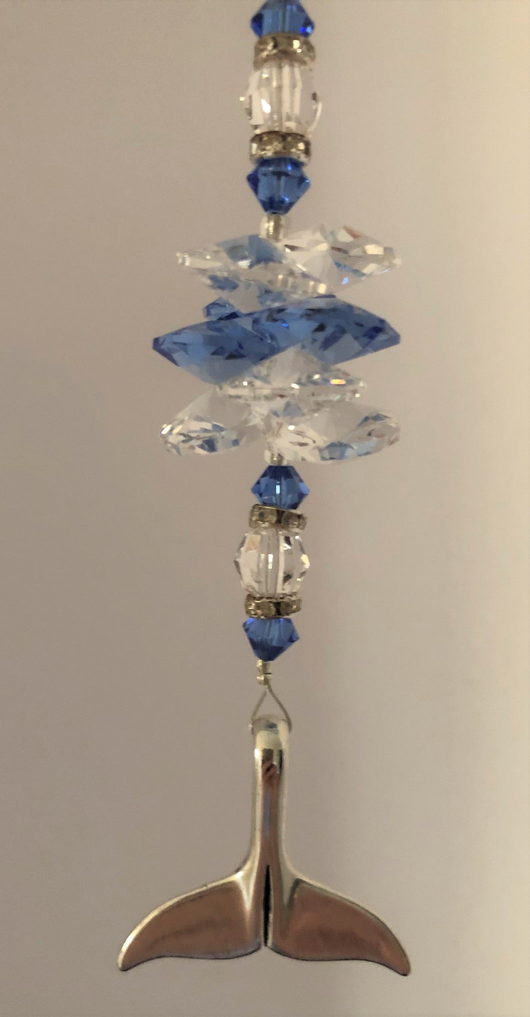 This beautiful Dolphin Tail suncatcher which is decorated with crystals and Blue Lace Agate