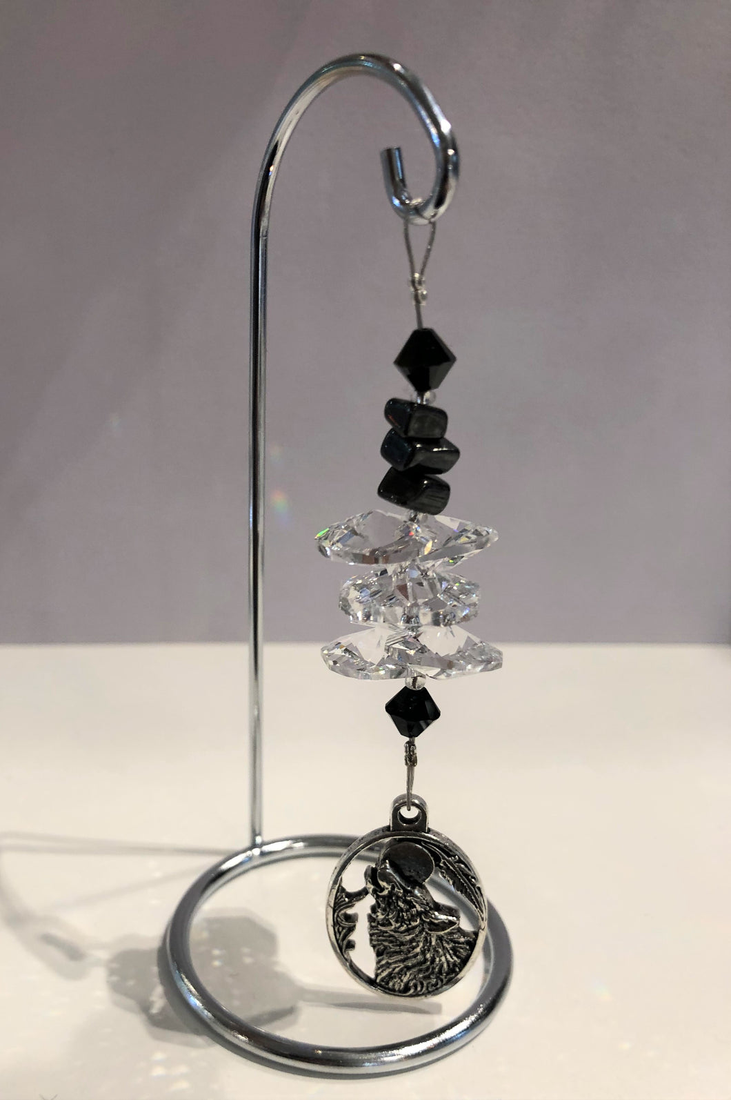 Wolf - crystal suncatcher is decorated with Hematite gemstones and come on this amazing small stand.
